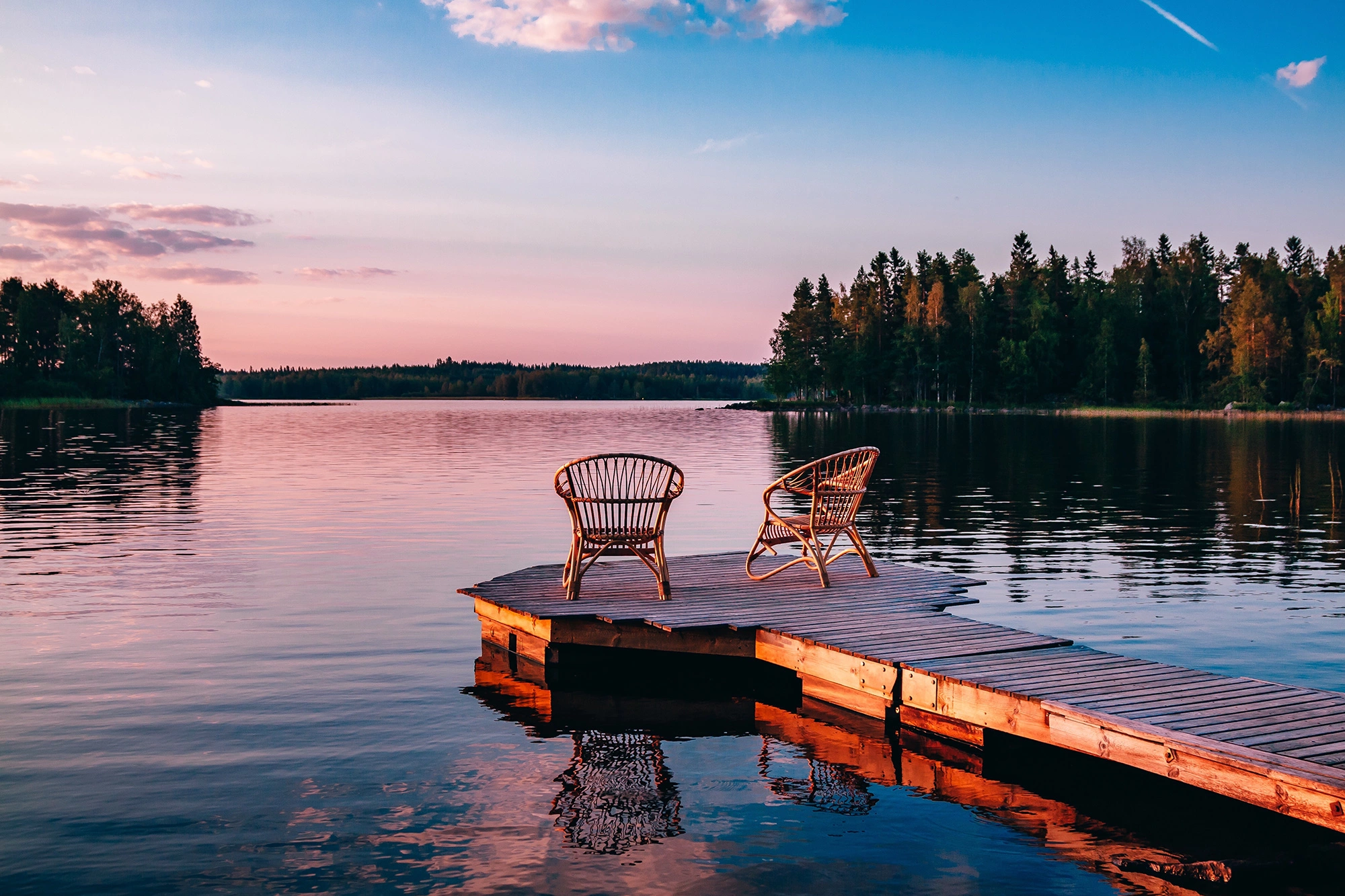 lake dock with chairs at sunset